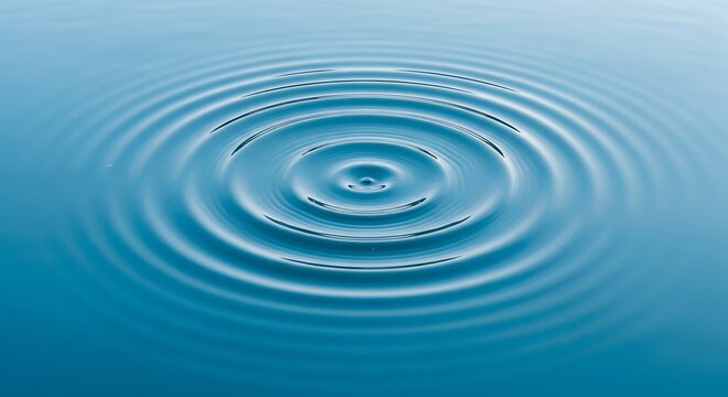 Concentric Ripple Water An abstract concentric ripple in calm blue water from an overhead view creating a serene pattern