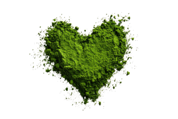 A heart-shaped clump of green powder,  surrounded by a scattered array of small specks and dots, against a black background