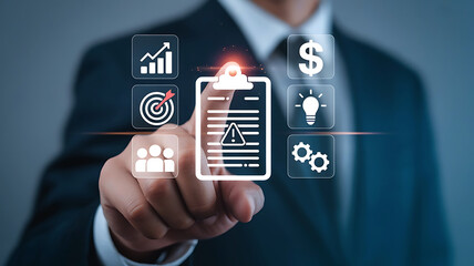 Businessman pointing at a digital clipboard with business icons representing strategy planning and financial goals