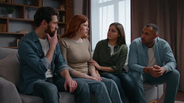 Four diversity friends at home party consoling crying woman talking about problem bad news breakup fired lost job multiethnic team buddies men women supporting cuddling group psychological friendship