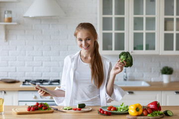 Beautiful smiling woman cooking in the kitchen