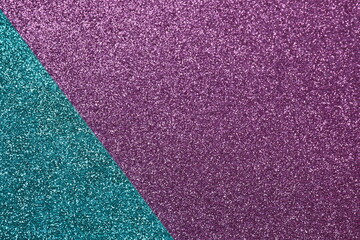 Fototapeta premium Abstract background filled with shiny purple and turquoisу glitter. Top view