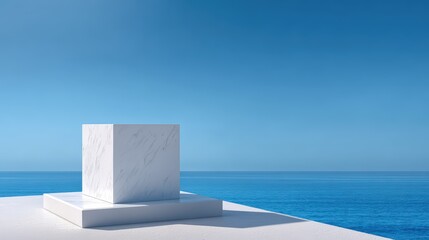 Minimalist white marble cube on a platform overlooking the ocean under a clear blue sky for modern design inspiration and abstract art concepts