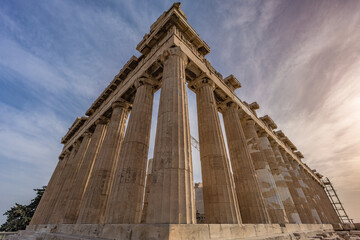 Wide angle view of the Parthenon on the Acropolis in Athens, Greece, showing ancient marble Doric columns of the classical Greek temple under the sky. 