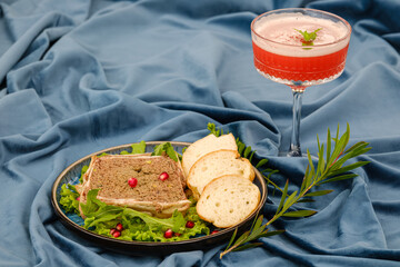 A delectable display of gourmet pate served on lettuce leaves, accompanied by slices of fresh...