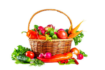 Fresh shiny different vegetables in a wicker basket. Isolated on white background.