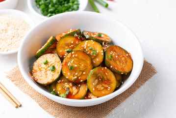 Korean cucumber salad (Oi muchim) in bowl on white background, Korean side dish