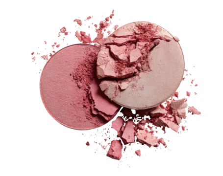 Two round blush compact discs, a pinkish-red and a light peach, are shown in close-up.  Crushed, scattered powder surrounds them
