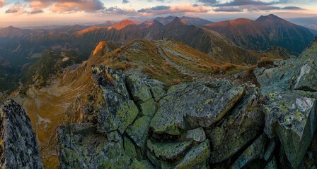 Breathtaking panoramic view of the Western Tatras in Slovakia during golden hour. Rocky mountain ridge, alpine lakes, and dramatic evening sky in pristine wilderness of the Carpathians.