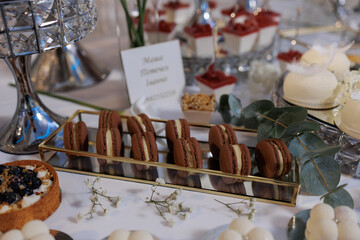 Elegant dessert display featuring assorted macarons and sweets at a refined event