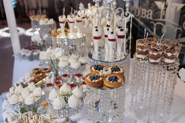 Elegant dessert table showcasing a variety of sweets at a festive event during the daytime