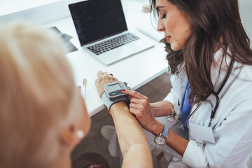 Healthcare Professional Taking Patient's Blood Pressure During Examination