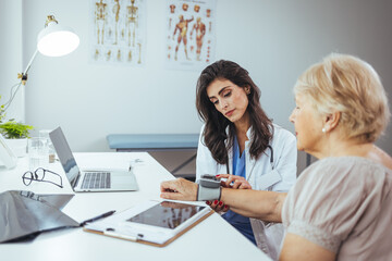 Doctor Measuring Blood Pressure of Elderly Patient During Health Consultation