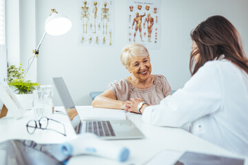 Fototapeta premium Doctor Consulting a Smiling Elderly Woman in a Bright Clinic Office