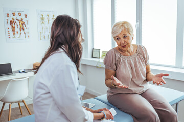 Senior Woman Discussing Health Concerns with a Doctor in a Modern Clinic