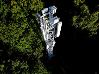 transmission of various drum shapes on a telecommunications tower. colors white and khaki green cones. transfer of phone signal and 5g, 4g internet. multiple TV antenna amplifier