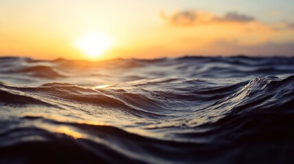 Mesmerizing sunset over undulating ocean waves reflecting warm golden light with a peaceful serene