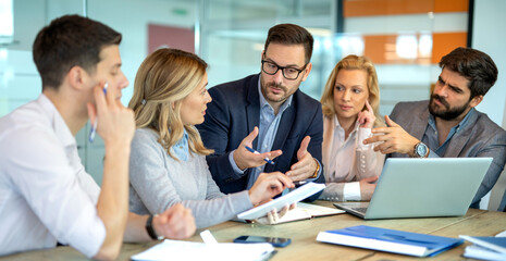 Business people fully engaged in discussion about company growth and future decisions