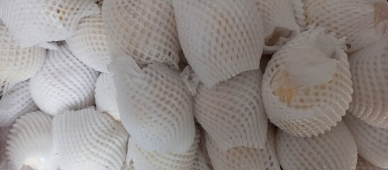 Pile of Fresh Guava Fruit in Protective Foam Netting