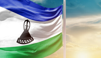 Lesotho national flag waving in an amazing sunlight. National flag waving on mast.