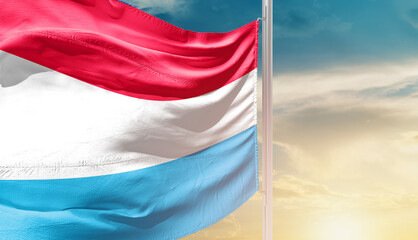 Luxembourg national flag waving in an amazing sunlight. National flag waving on mast.