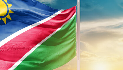 Namibia national flag waving in an amazing sunlight. National flag waving on mast.