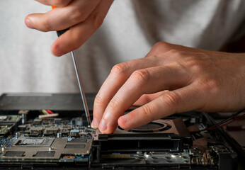 Computer service – technician removing laptop cooling system