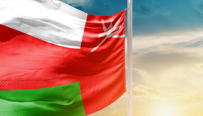 Oman national flag waving in an amazing sunlight. National flag waving on mast.