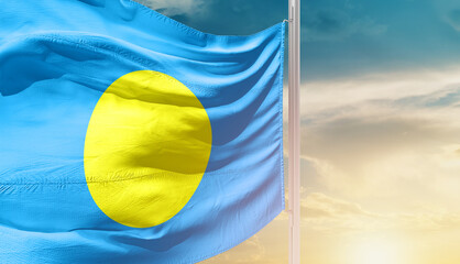 Palau national flag waving in an amazing sunlight. National flag waving on mast.