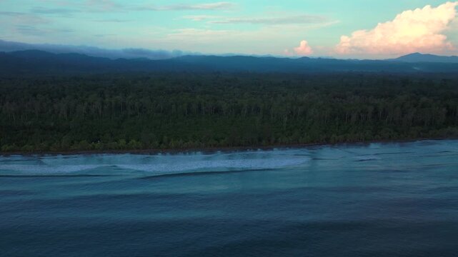 Cape Wom Meri beach Dogreto Bay Madang Harbor View Papua New Guinea aerial drone untouched remote tropical shore waves Kavieng Vanimo Tufi coastline rain clouds fog sunny skies morning to right