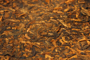 Close-up view of a puer tea cake reveals its intricate texture and rich color.
