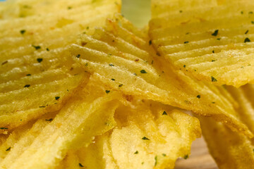 Crispy flavorful chips stacked high in a bowl against, extreme close-up