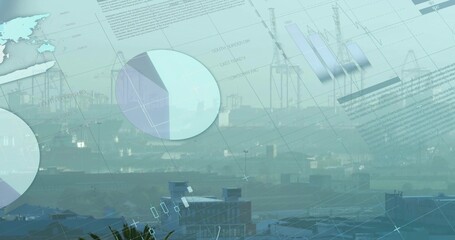 Silhouetting gantry cranes and warehouse roofs at waterfront port, overlaying data visuals