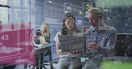 Discussing woman in business attire holding laptop and man gesturing in office, with data overlay