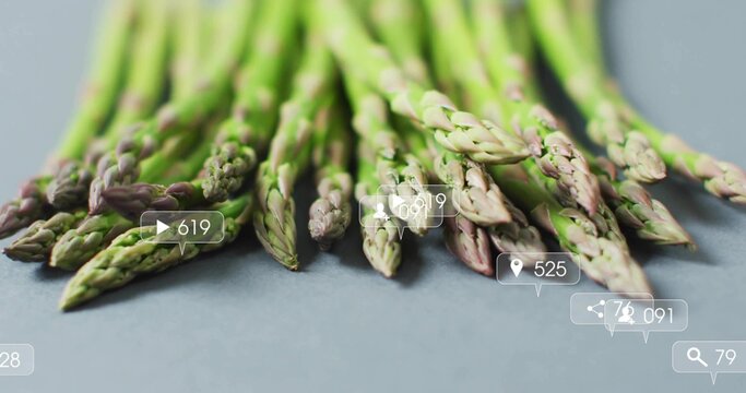 Showcasing green asparagus spears resting on studio countertop, featuring social media icons - Powered by Adobe