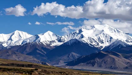 Snowy mountain range under a partly cloudy sky