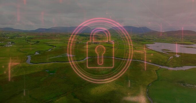 Hovering neon pink digital padlock icon showing security interface over rural fields with waterways - Powered by Adobe