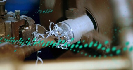Machining cylindrical metal workpiece rotating on lathe station, with chips and green data overlay