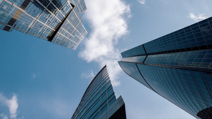 bottom view of the tall skyscrapers of the business district of a modern city