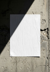Blank white wrinkled paper poster with a creased texture and a sharp diagonal shadow cast across its surface.