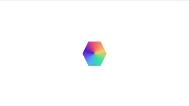 A vibrant hexagonal shape with a gradient of rainbow colors, set against a clean white background.