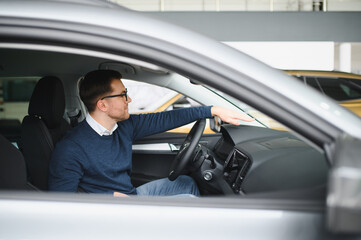 Man buying a car at a showroom