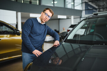 Man buying a car at a showroom