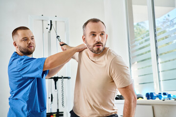 Rehabilitation session between a patient and his physiatrist in a modern center