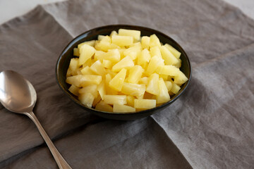 Canned Pineapple Tidbit Chunks in a Bowl, side view.