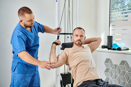 Physical rehabilitation session with patient and physiatrist in a modern center