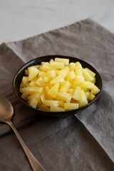 Canned Pineapple Tidbit Chunks in a Bowl, side view.