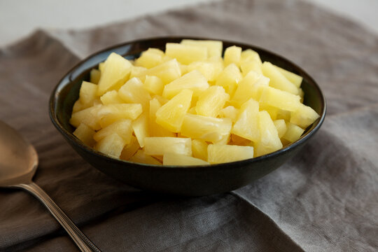 Canned Pineapple Tidbit Chunks in a Bowl, side view.