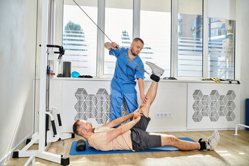Patient receiving physical therapy at a rehabilitation center by skilled physiatrist