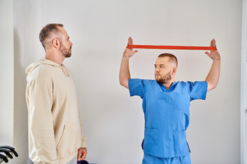 Patient engaging in physical therapy with doctor at a rehabilitation center
